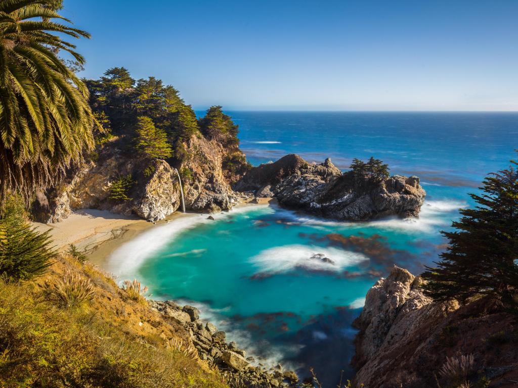 McWay Falls in scenic golden evening light with blue sky in summer, Julia Pfeiffer Burns State Park, Big Sur, California