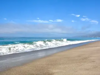 Sandy shores, rolling waves and blue skies across Zuma Beach
