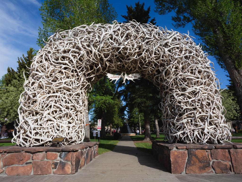 Antler Arch, constructed using naturally shed elk antlers, in Jackson, Wyoming on a sunny day