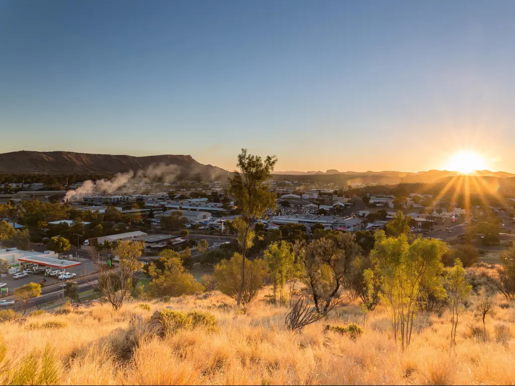 Alice Springs, Australia with a view of Alice Springs in the distance taken at sunset.