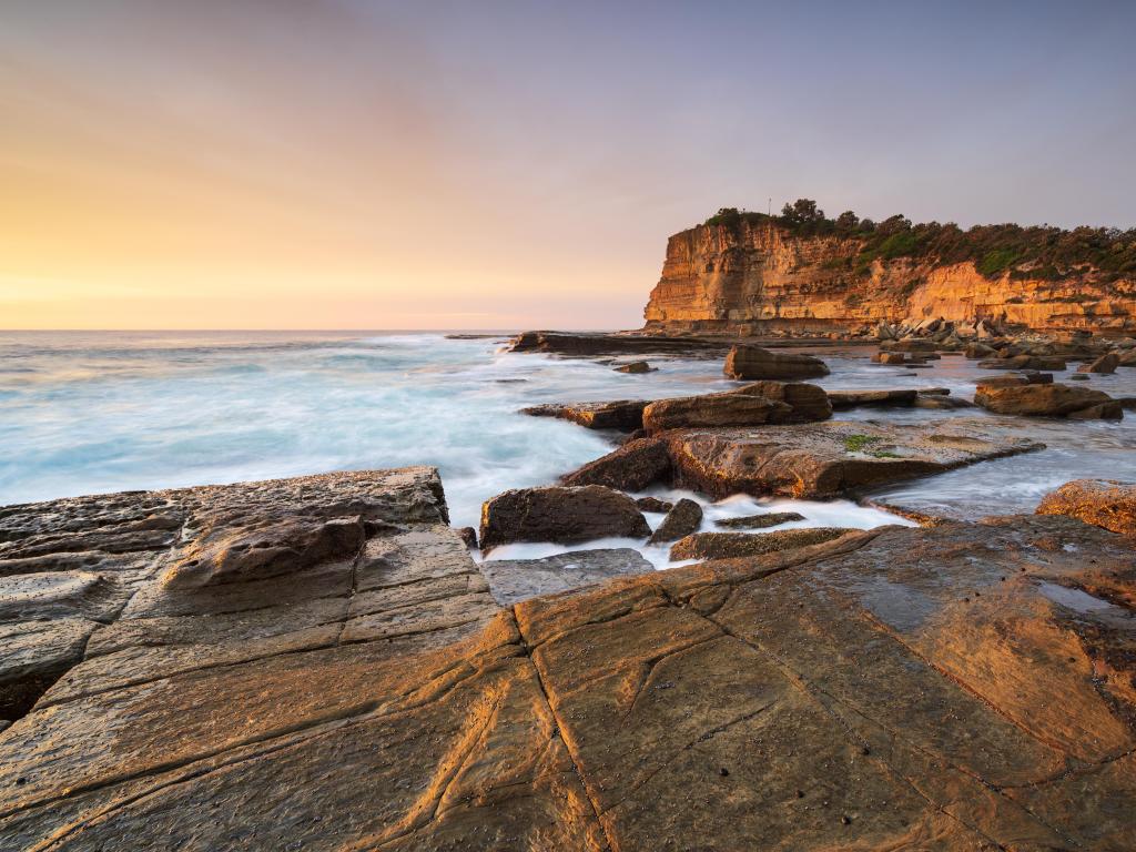 Rocky cliffs rise up from ocean