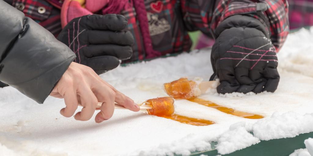 People making maple taffy in the snow in Quebec