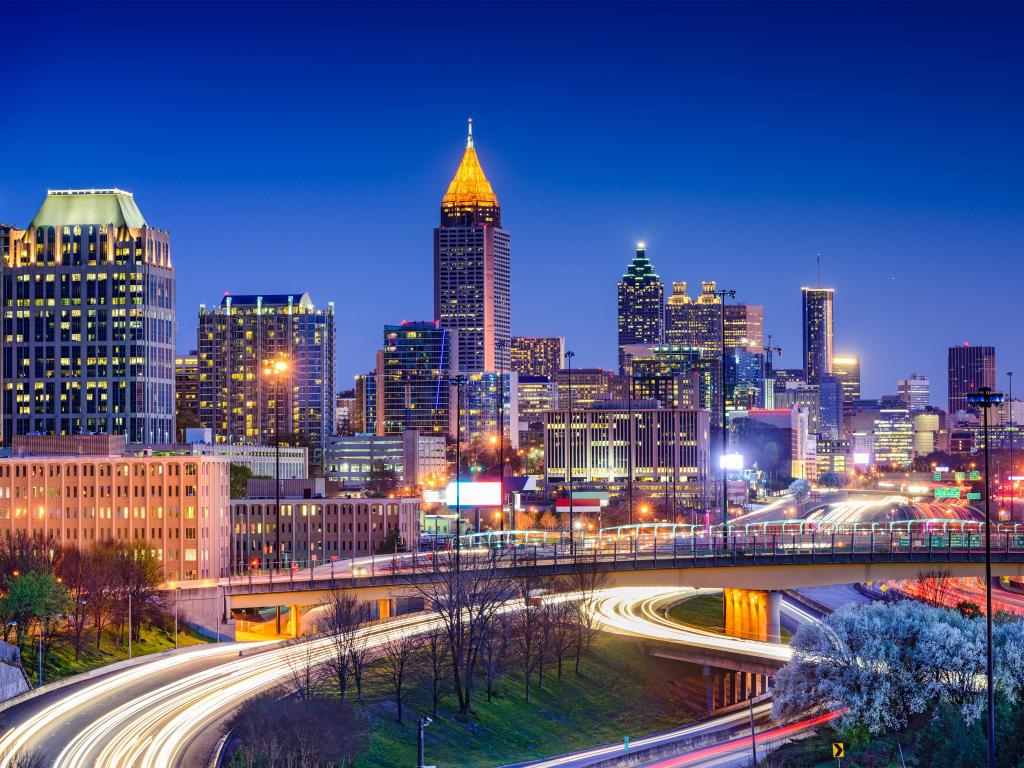 Atlanta, Georgia, USA downtown skyline taken at night with the skyscrapers lit up in the background.