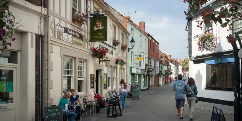 A couple strolling through the quaint streets of Glastonbury town in Somerset 