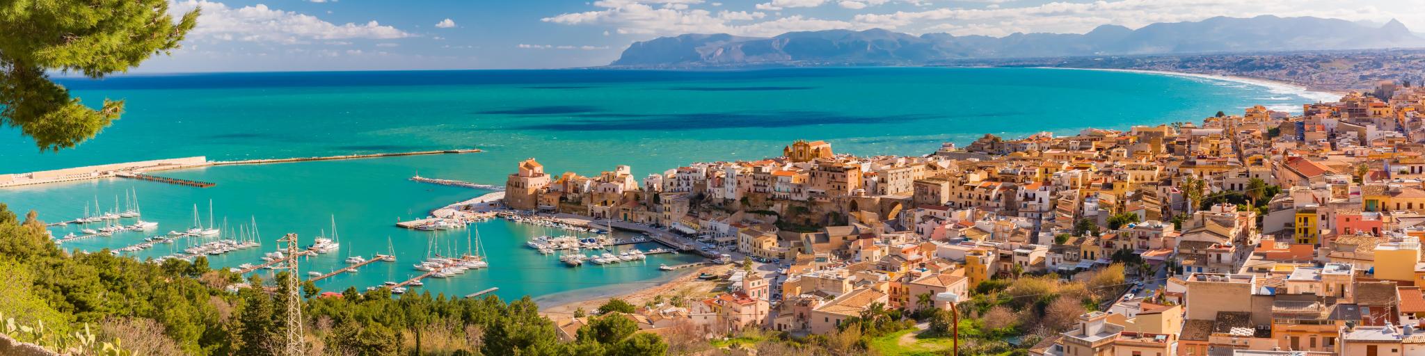 Beautiful panoramic view of medieval fortress in Cala Marina, harbor in coastal city Castellammare del Golfo in the morning, Sicily, Italy
