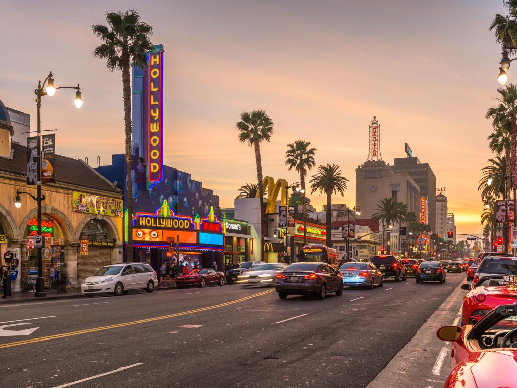 Los Angeles, California, USA showing traffic on Hollywood Boulevard at dusk. The theater district is famous tourist attraction.
