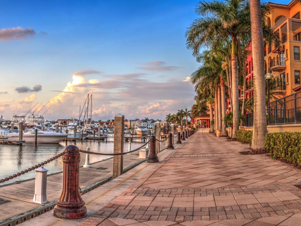 Marco Island, Florida, USA with a sunset over the boats in Esplanade Harbor Marina.