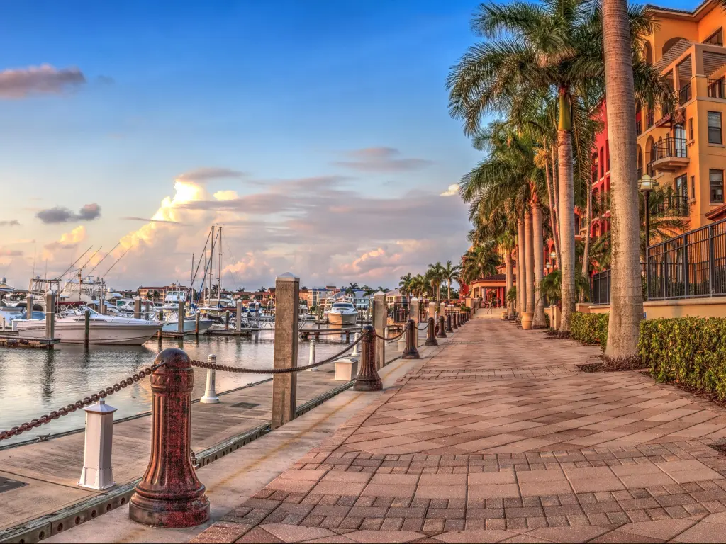 Marco Island, Florida, USA with a sunset over the boats in Esplanade Harbor Marina.