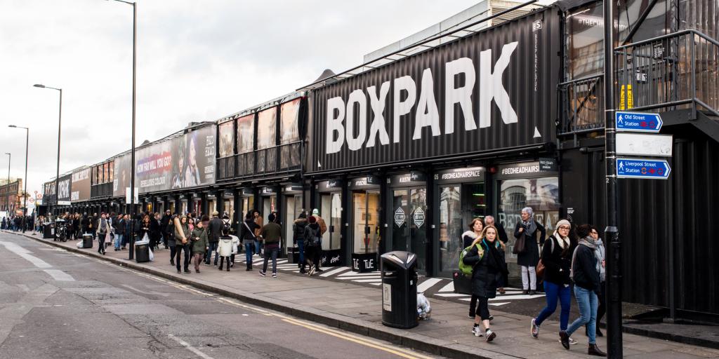 The outside of Boxpark, Shoreditch with people walking past 