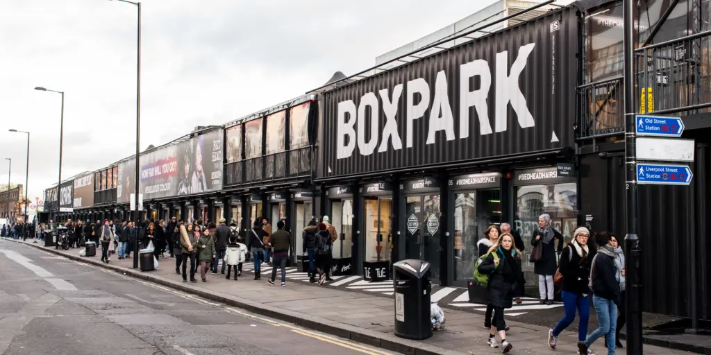 The outside of Boxpark, Shoreditch with people walking past 
