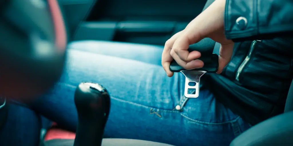 Shot of a person's hands fastening their seat belt