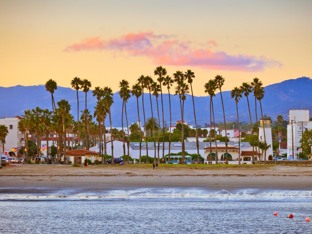 Santa Barbara beach and city with mountains in the background as seen from the pier at dusk.