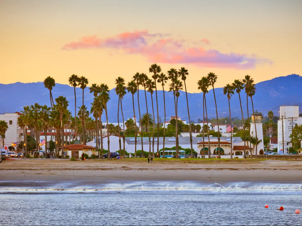 Santa Barbara beach and city with mountains in the background as seen from the pier at dusk.