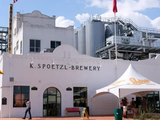 White exterior of Spoetzl Brewery on a sunny day