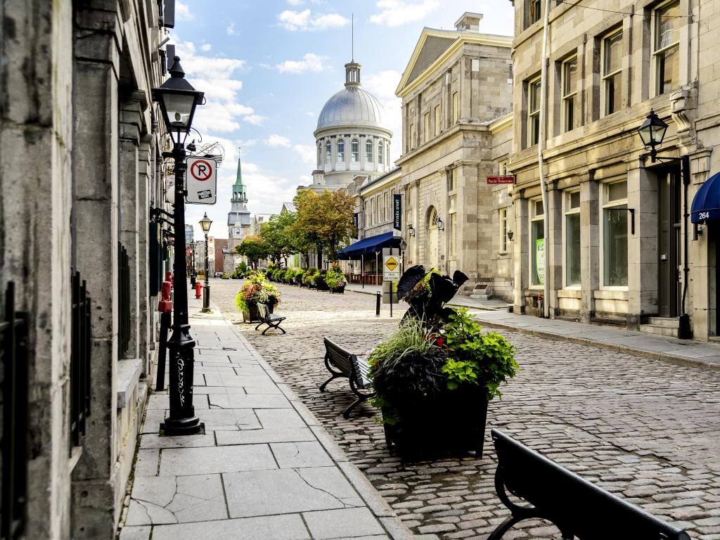 Old city Montreal, Canada taken on an early summer morning with a cobblestone street and historic buildings.