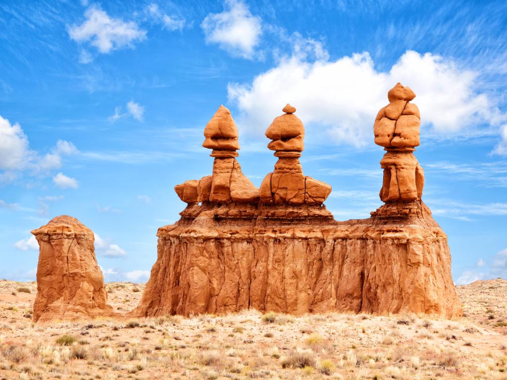 Goblin Valley State Park, Utah, USA with the striking rock formations in the foreground against a blue sky.