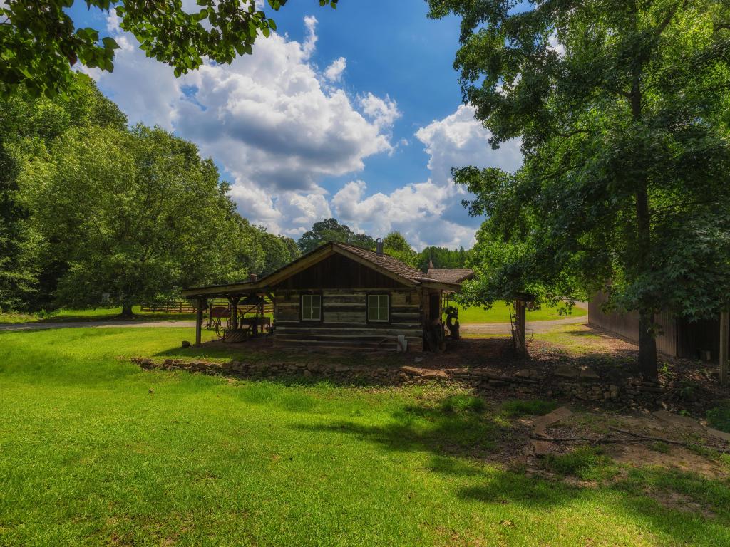 French Camp, Mississippi, USA taken at the Old Blacksmith building at French Camp Academy, on a sunny day with trees surrounding.