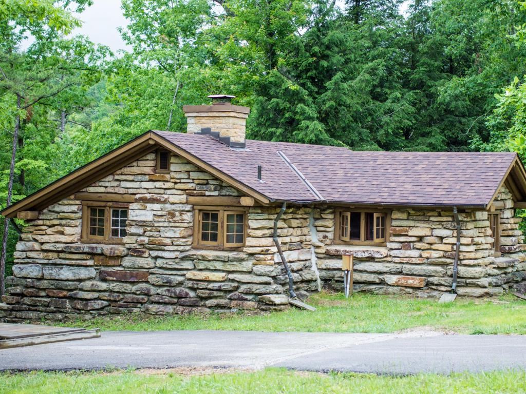 Historic stone property in public park nestled among trees