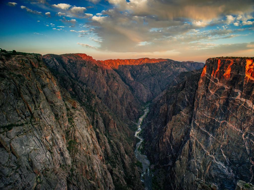 Black Canyon of the Gunnison National Park, Colorado, USA taken at sunset with the valley and river below and two rocky mountains either side.