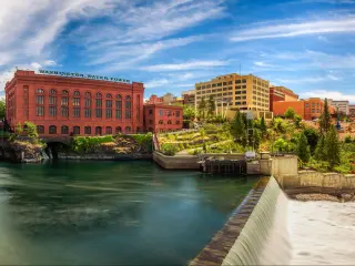 Panoramic view of the Washington Water Power building and Monroe Street Bridge by the Spokane River in Spokane, Washington