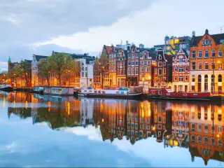 Night city view of Amsterdam, the Netherlands with Amstel river