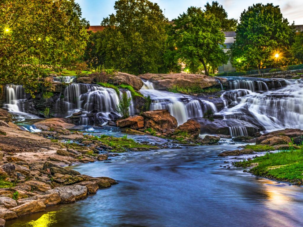 Greenville, South Carolina, USA taken at Reedy River Falls in downtown Greenville with stunning waterfalls, rocks and trees surrounding.