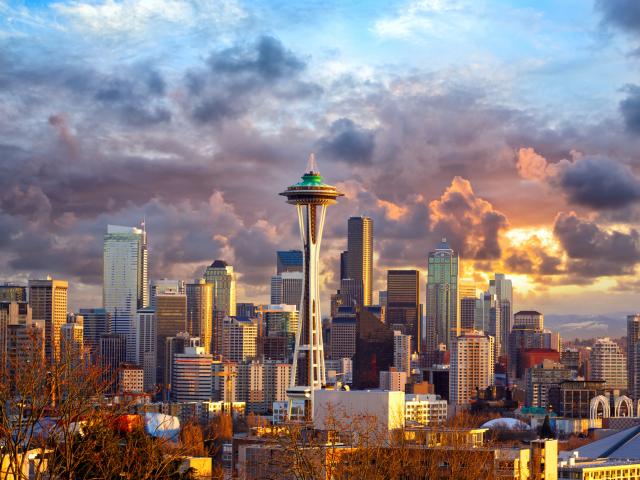 The futuristic Space Needle dominates the Seattle skyline on a cloudy day