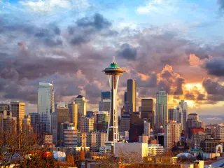 The futuristic Space Needle dominates the Seattle skyline on a cloudy day