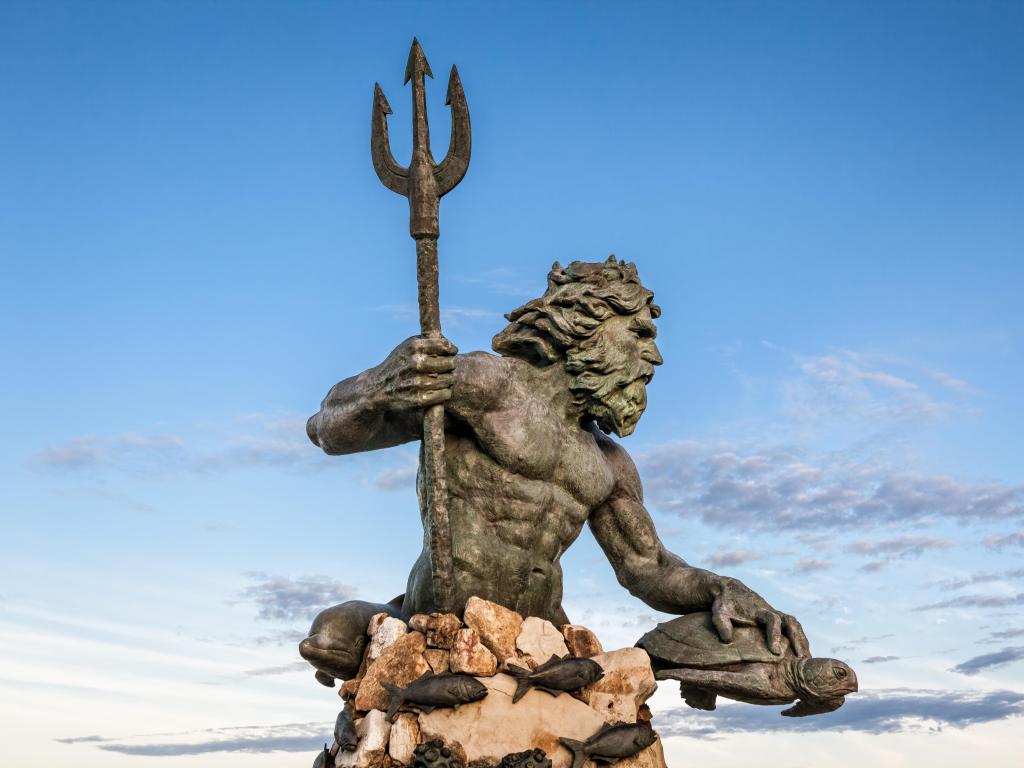 King Neptune statute, famous tourist attraction at Virginia Beach against a blue sky in summer.