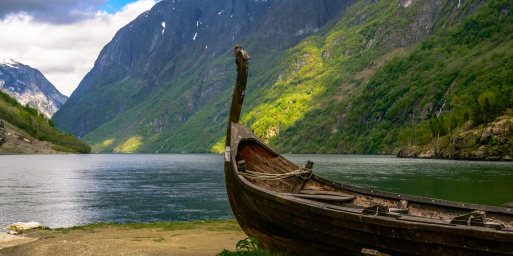 A boat sits on the banks of a fjord in Norway