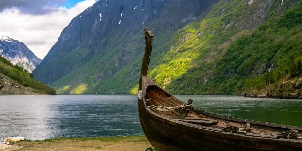 A boat sits on the banks of a fjord in Norway