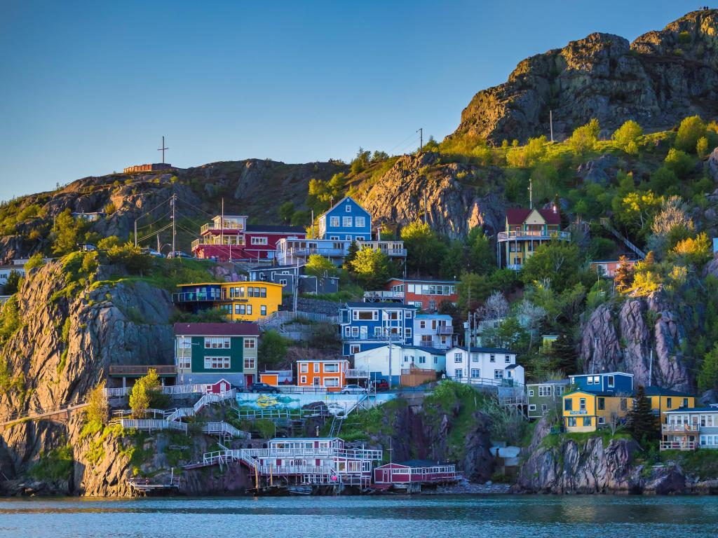 Colorful houses at downtown Saint John by a cliff over the water in Newfoundland Canada