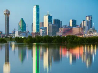 Beautiful and recognizable Dallas skyline at dusk, with reflections of the skyscrapers in the Trinity River.