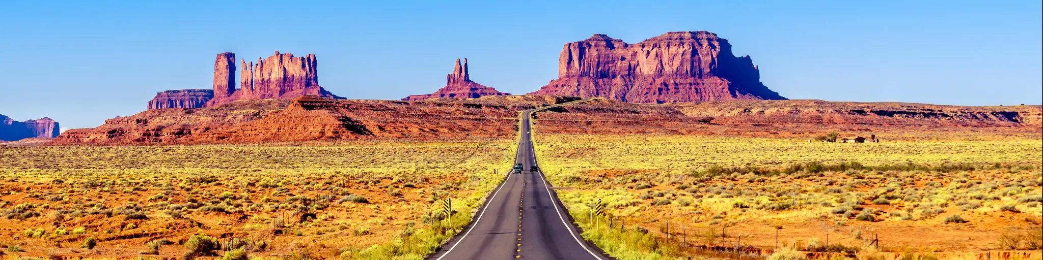 Highway 163 leading to the towering sandstone Buttes and Mesas of the Monument Valley Navajo Tribal Park in Utah-Arizona, United States. 'Forest Gump Point' where he stopped his cross country run