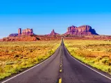 Highway 163 leading to the towering sandstone Buttes and Mesas of the Monument Valley Navajo Tribal Park in Utah-Arizona, United States. 'Forest Gump Point' where he stopped his cross country run