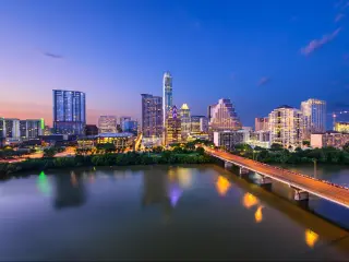 Austin, Texas, USA with the downtown skyline at night over the Colorado RIver.