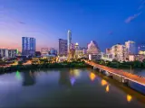 Austin, Texas, USA with the downtown skyline at night over the Colorado RIver.