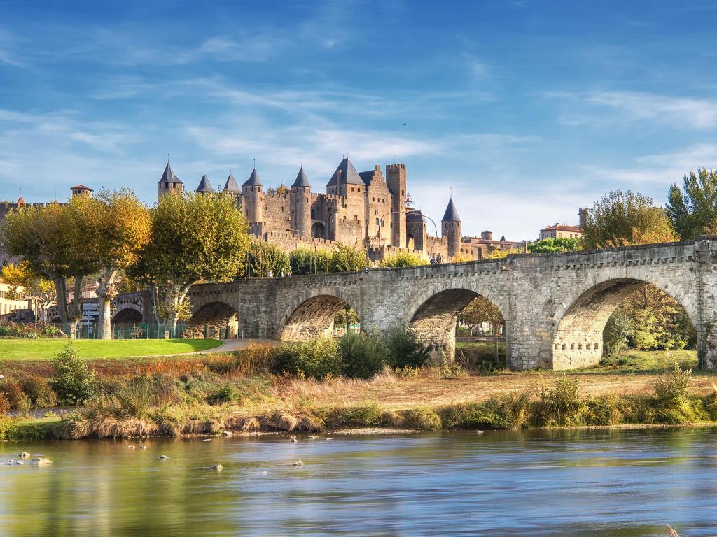 Carcassonne, Southern France and the Le Pont Vieux bridge viewed from across the Aude river. 