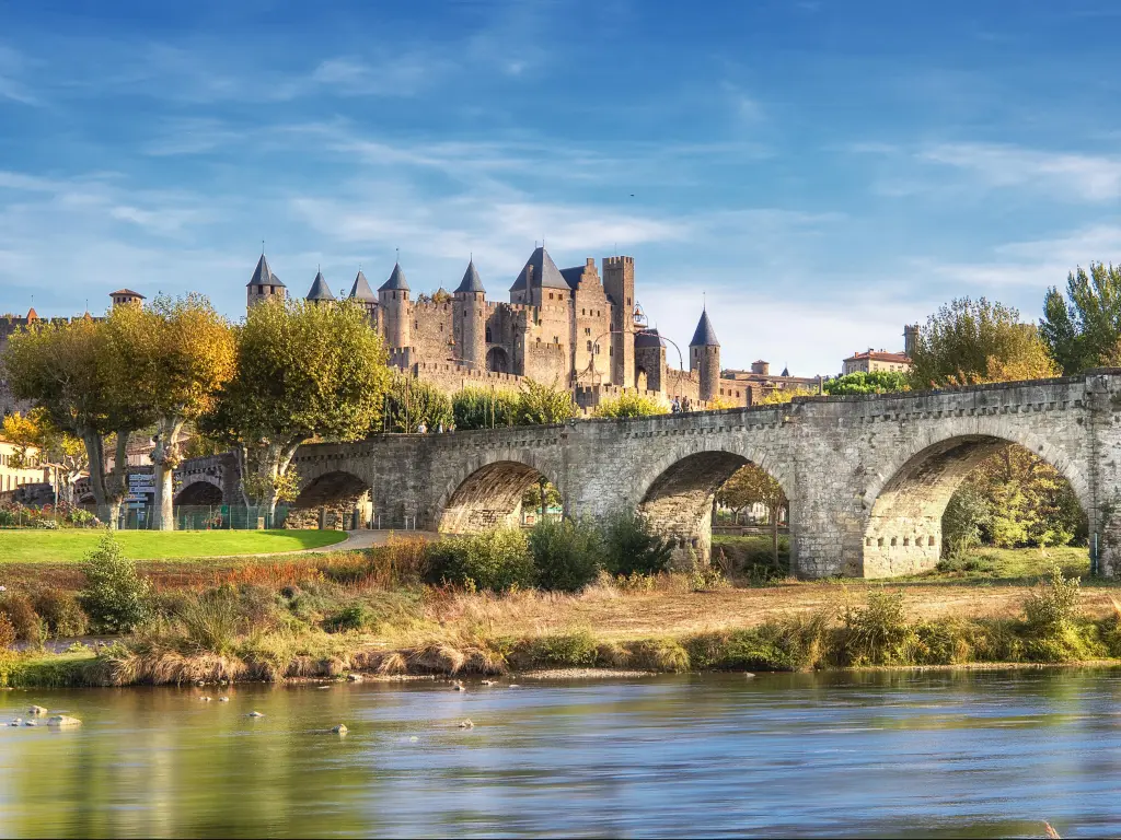 Carcassonne, Southern France and the Le Pont Vieux bridge viewed from across the Aude river. 