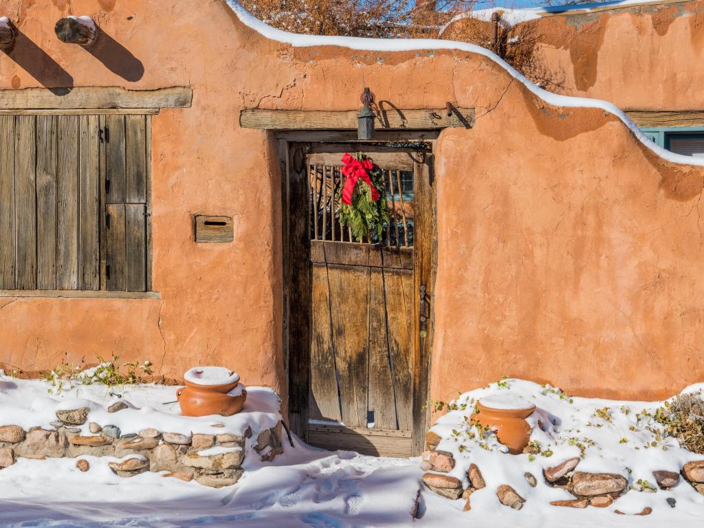 Traditional houses in Santa Fe in winter, with a festive wreath on a door