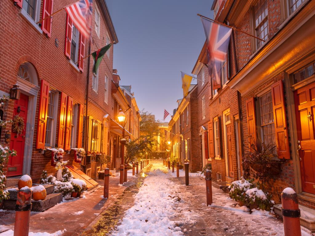 Old, lit-up alleyway in Philadelphia under snow