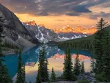 Dramatic sunrise at the Moraine lake in Banff National Park, snow capped mountains in the background