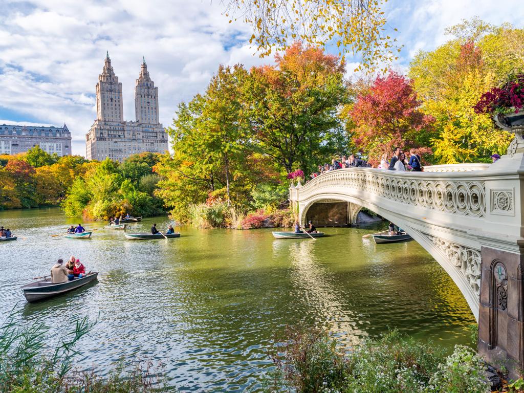 Tourists on boats in Central Park, New York, in autumn