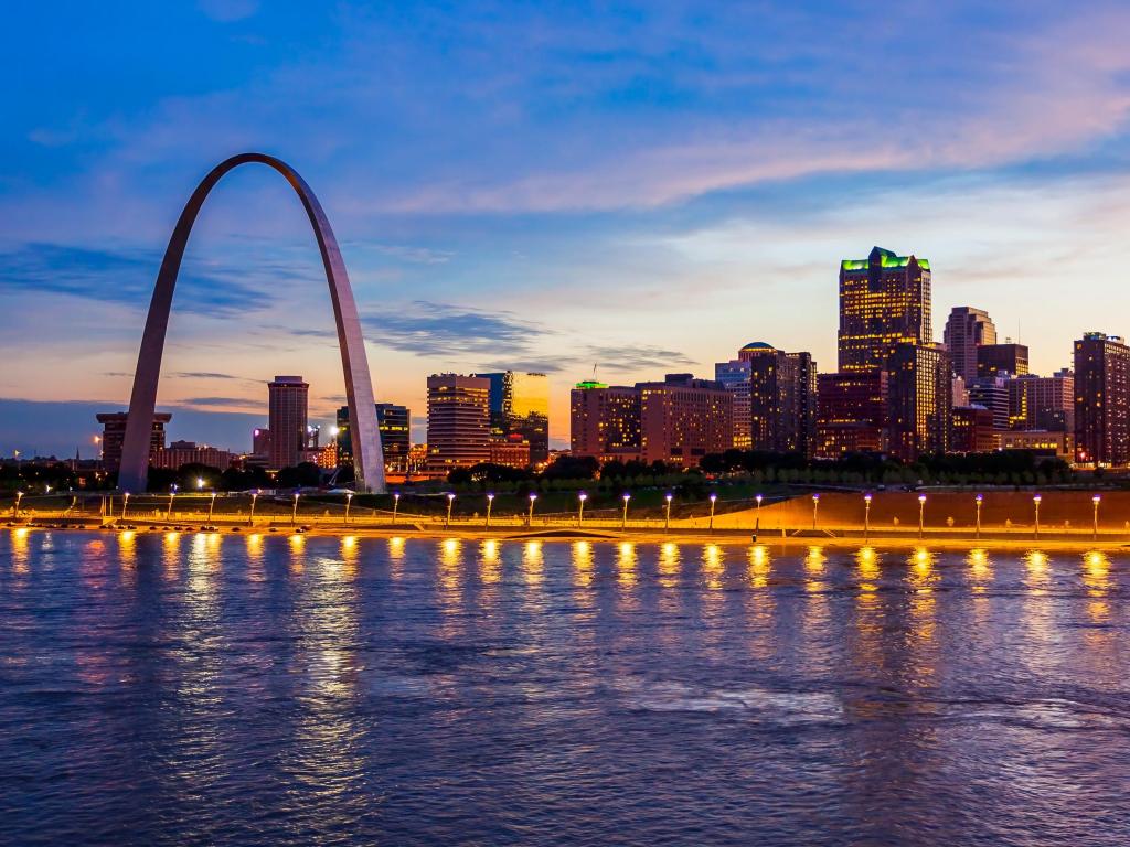 St Louis skyline with the Gateway Arch, at night, with lights reflecting on the water