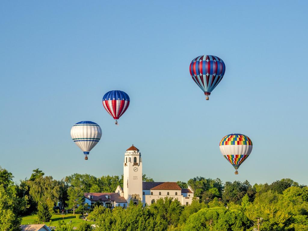 View of colorful hot air ballons floating above the Boise Train Depot