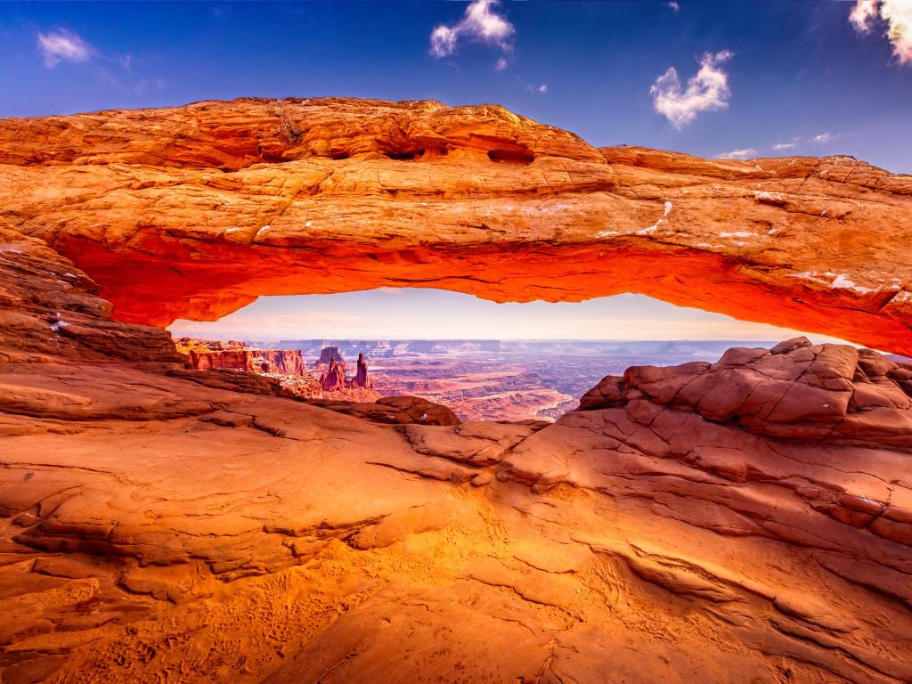 Arches National Park, Utah, USA taken at the famous Mesa Arch looking through the red formations in the distance on a sunny day.