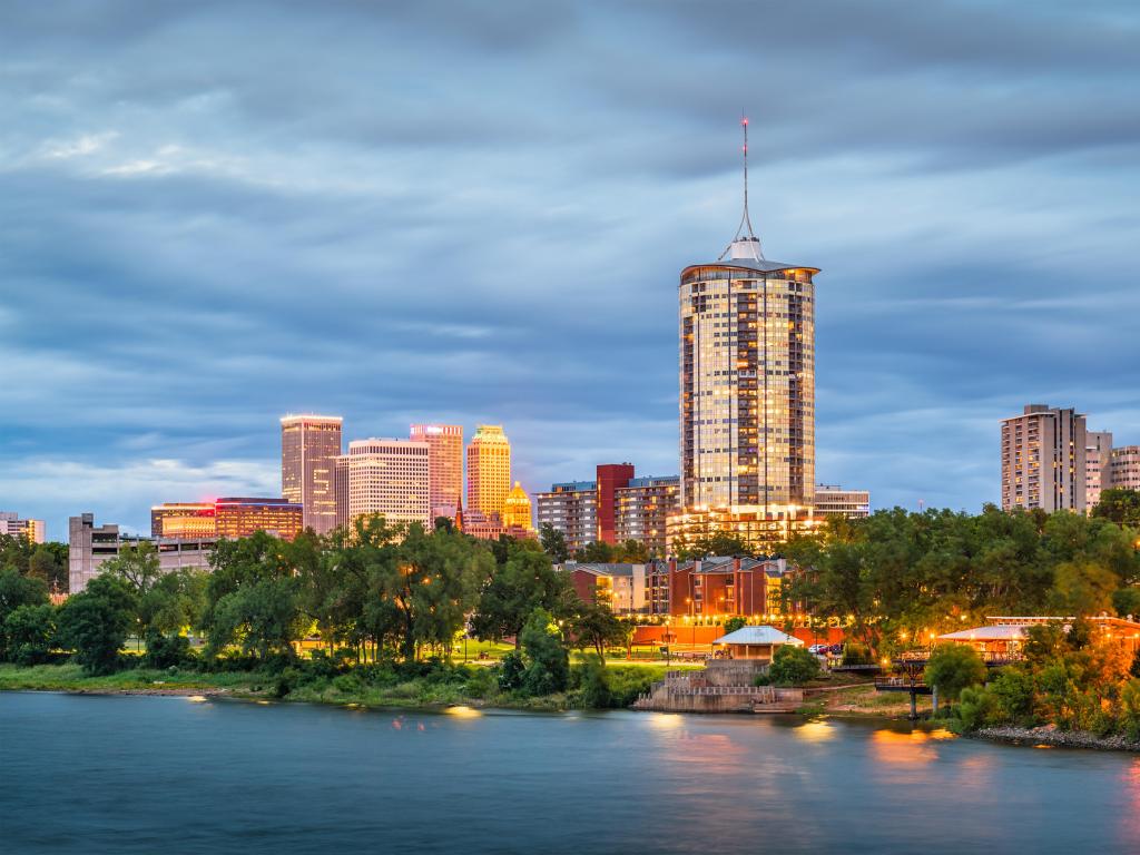 Tulsa, Oklahoma, USA with the downtown skyline in the distance and the Arkansas River at dusk in the foreground. 