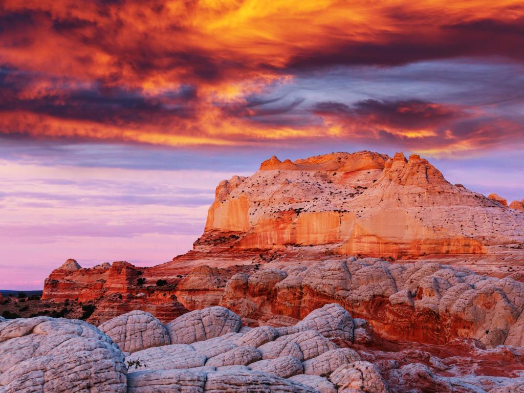 Vermilion Cliffs National Monument, Arizona at sunrise with a dramatic sky over the red rocky cliffs in the foreground.