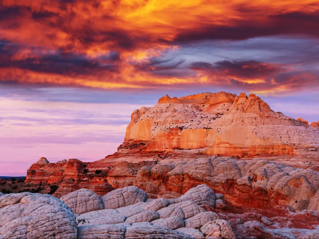 Vermilion Cliffs National Monument, Arizona at sunrise with a dramatic sky over the red rocky cliffs in the foreground.