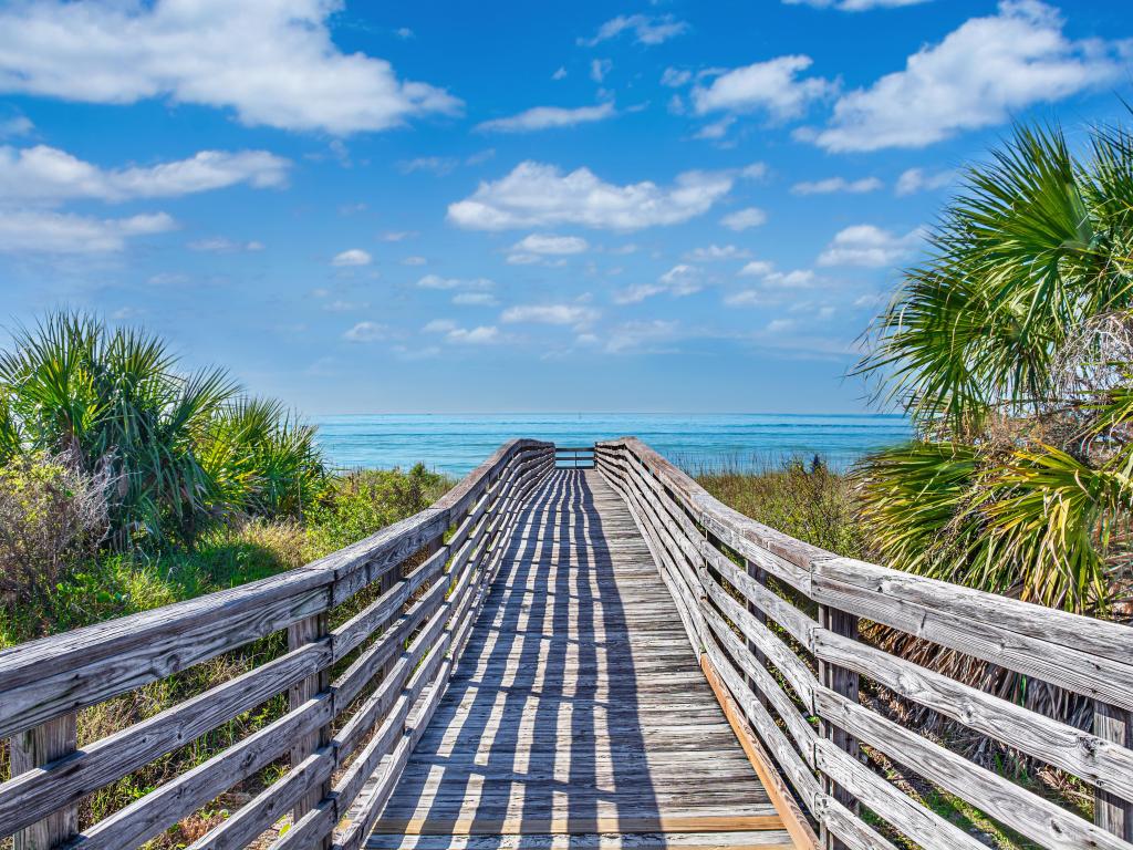 Wooden bridge leading to pristine white sands on Honeymoon Island, FL